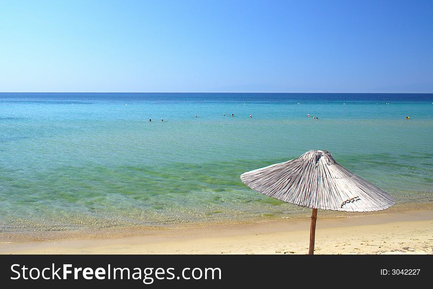 Beach with umbrellas in the morning in Greece