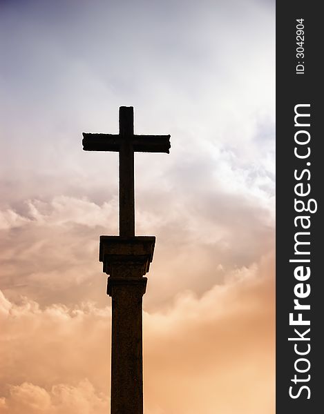 Cross silhouette and the clouds at sunset