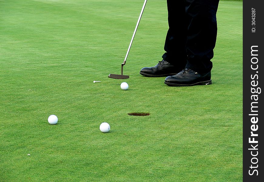 Shot of putting, three balls and one in movement. Shot of putting, three balls and one in movement