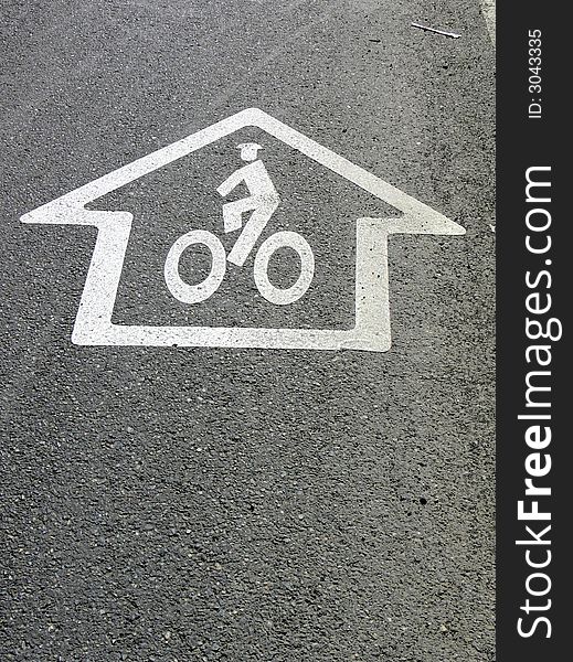 Shot of a bike sign on the pavement. Shot of a bike sign on the pavement.