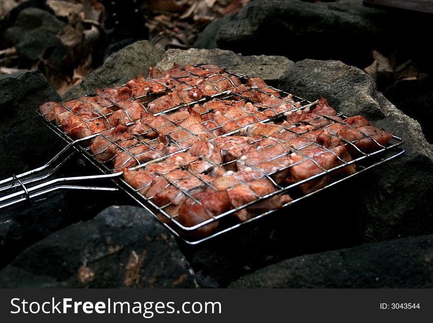 Meat roasted on open fire between stones. Meat roasted on open fire between stones