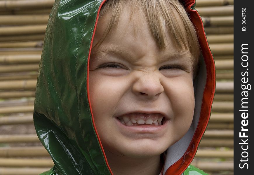 Cute, smiling baby in front of a bamboo background. Cute, smiling baby in front of a bamboo background.