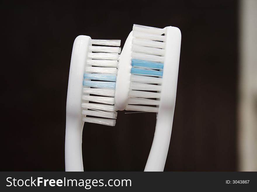 On a photo two tooth-brushes with a tooth-paste. A photo close up