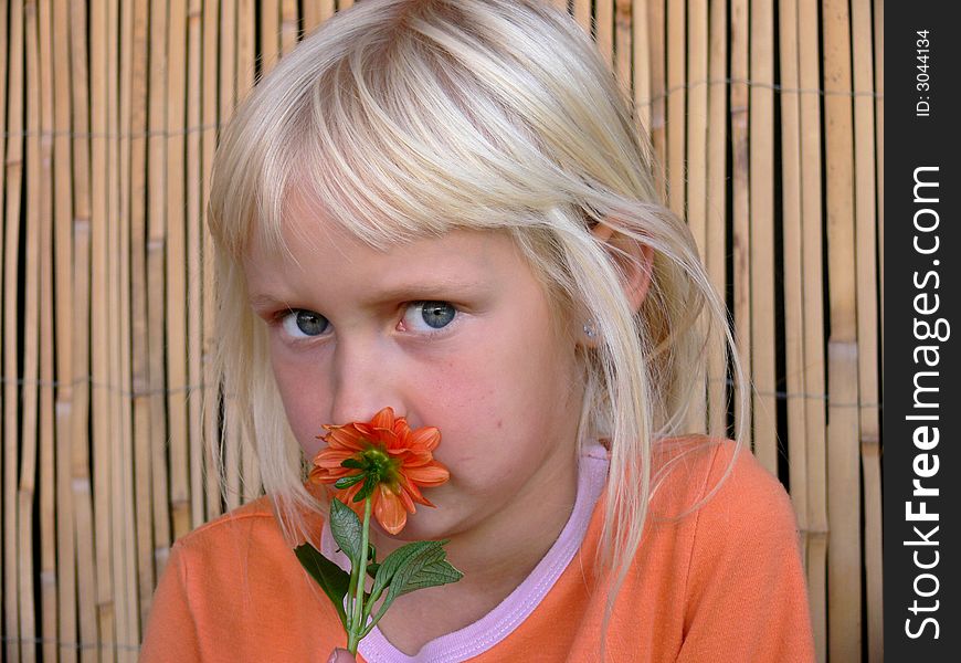 Girl smelling  a  flower