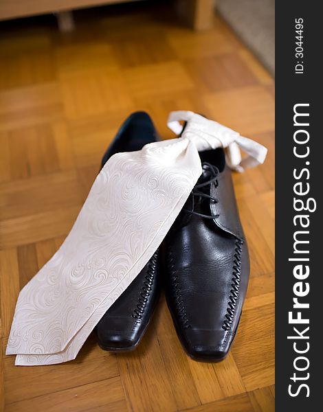 Necktie on black leathershoes. Clothes for the groom, shortly before a wedding. Small DOF. Necktie on black leathershoes. Clothes for the groom, shortly before a wedding. Small DOF.