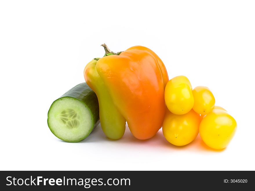 Cucumber, bell pepper and four yellow tomatoes isolated on white. Cucumber, bell pepper and four yellow tomatoes isolated on white