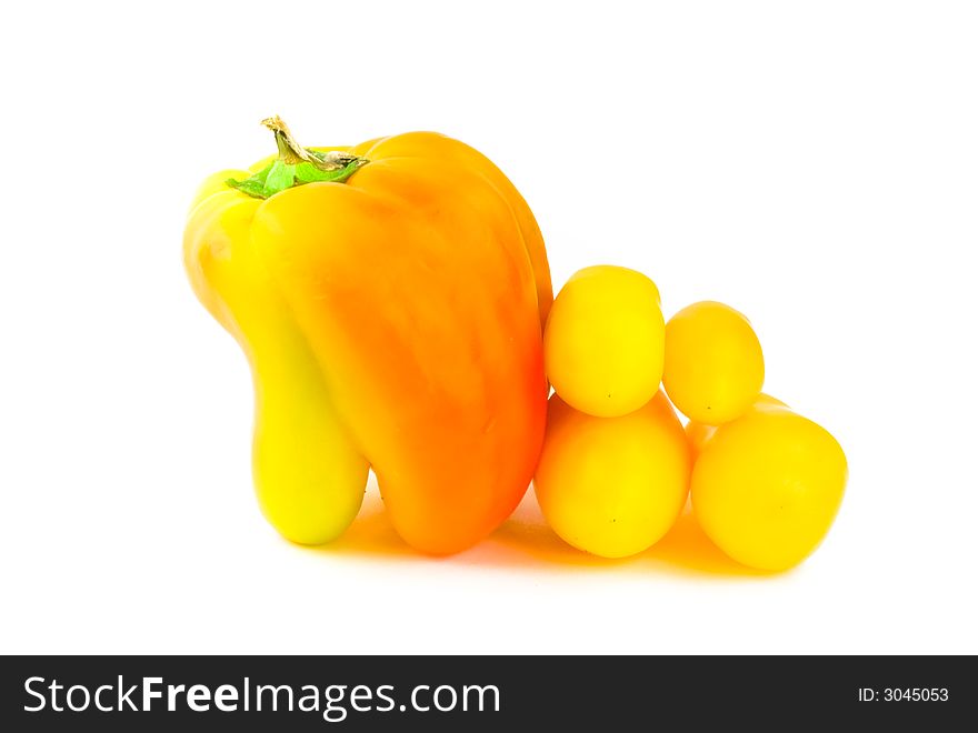 Orange bell pepper with four yellow tomatoes isolated on white. Orange bell pepper with four yellow tomatoes isolated on white