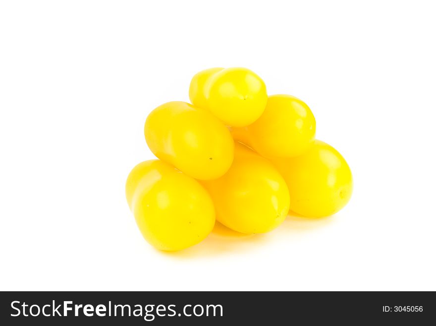 Pile of yellow tomatoes isolated on white