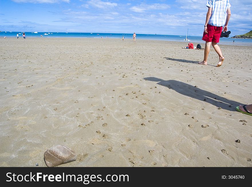 People walking on the beach, going swimming