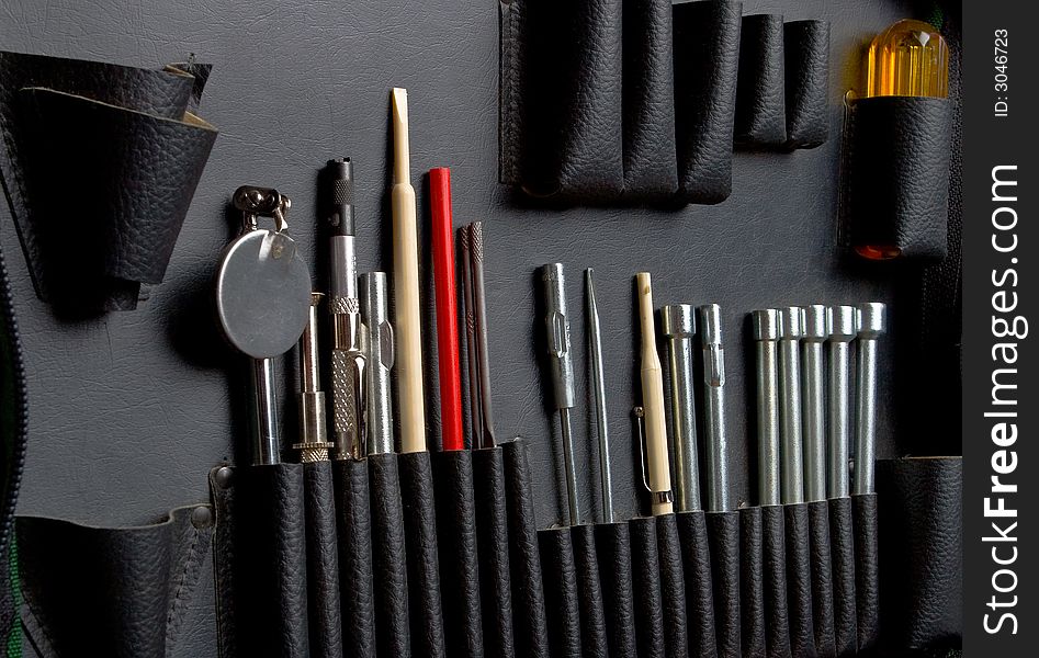 Tool kit in a bag with leather pockets close up