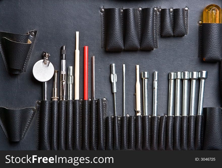 Tool kit in a bag with leather pockets close up. Tool kit in a bag with leather pockets close up