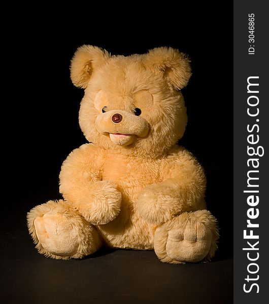 Yellow bear isolated on black. Yellow bear isolated on black