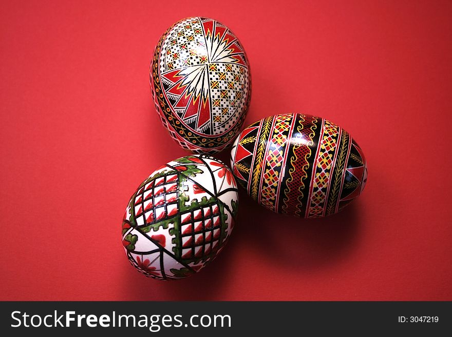 Three easter eggs isolated on red