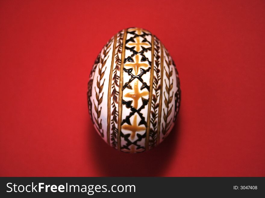 One easter egg isolated on red