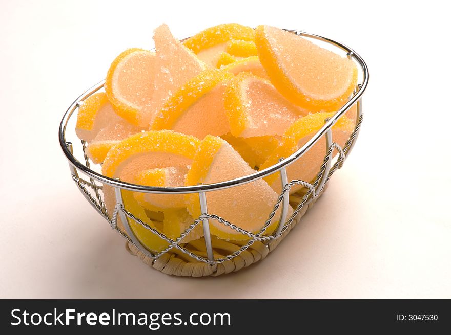 Small wicker vase full of fruit orange candy. Small wicker vase full of fruit orange candy