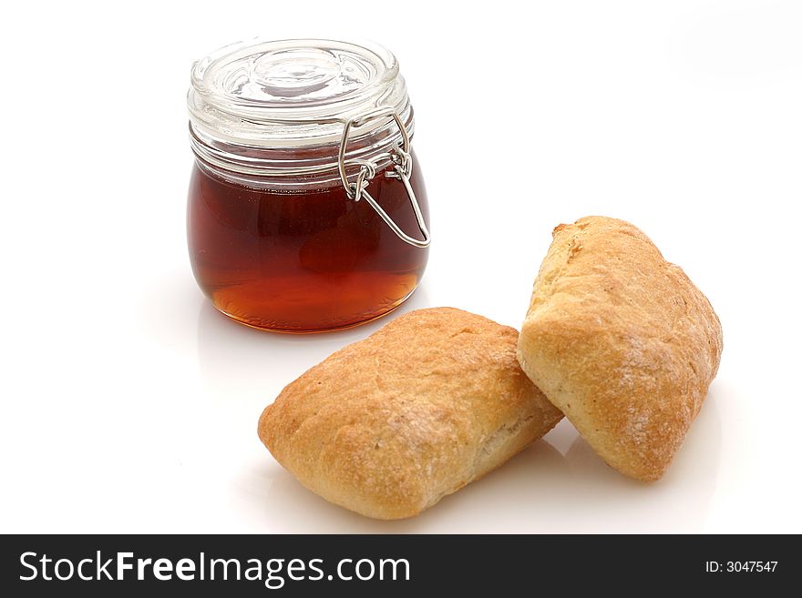 Honey and Bread rolls isolated on white