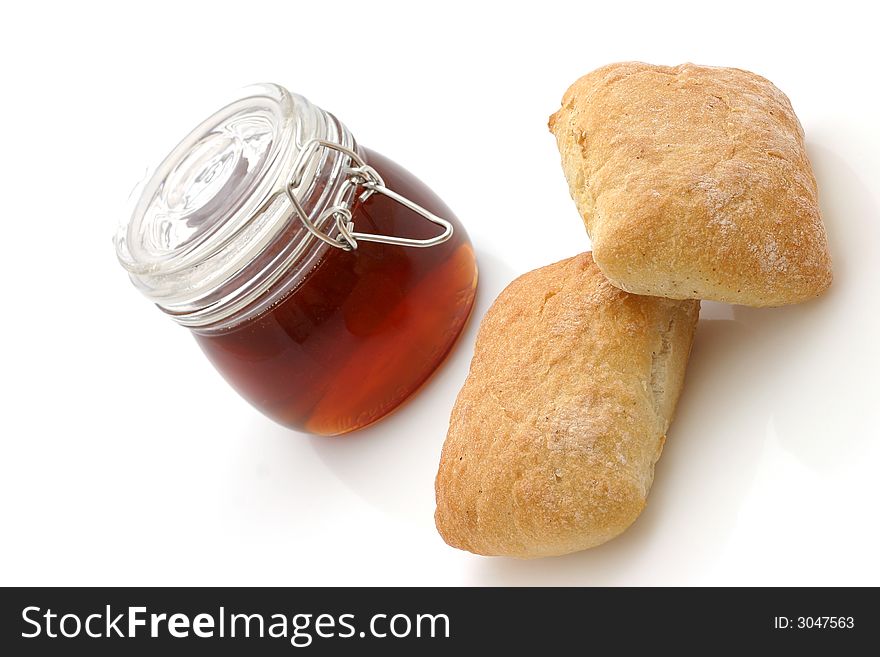 Honey and Bread rolls isolated on white