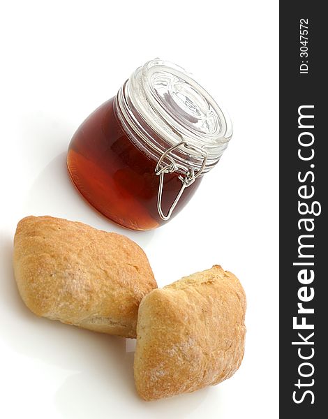 Honey and Bread rolls isolated on white