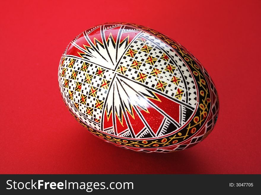 One easter egg isolated on red