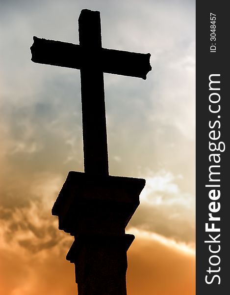 Cross silhouette and the clouds at sunset