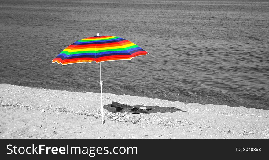 Colorful umbrella on the beach with a black and white background