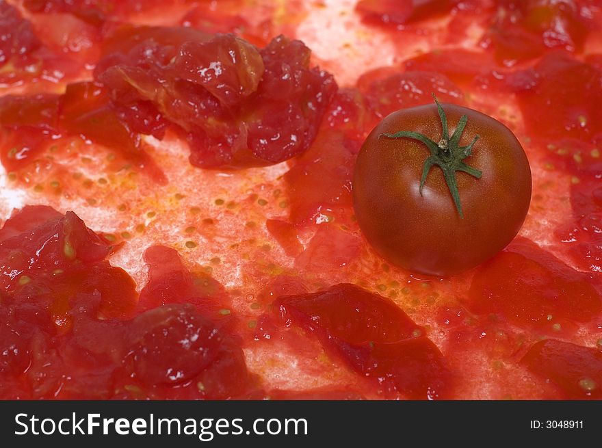 Single tomato on squeezed tomato. Single tomato on squeezed tomato