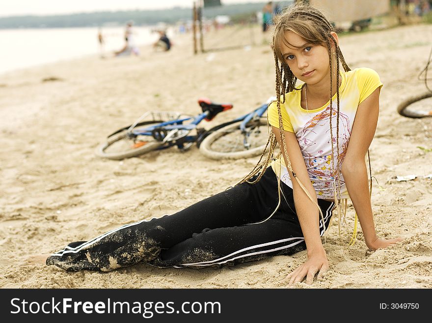 The little girl with long hair on beach. The little girl with long hair on beach