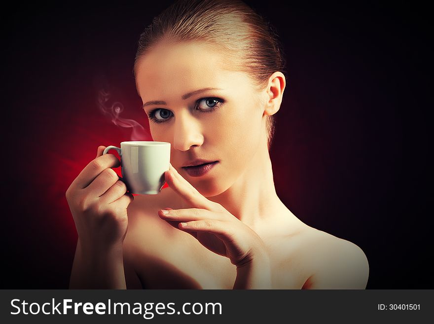 Sexy Woman Enjoying A Hot Cup Of Coffee On A Dark Background