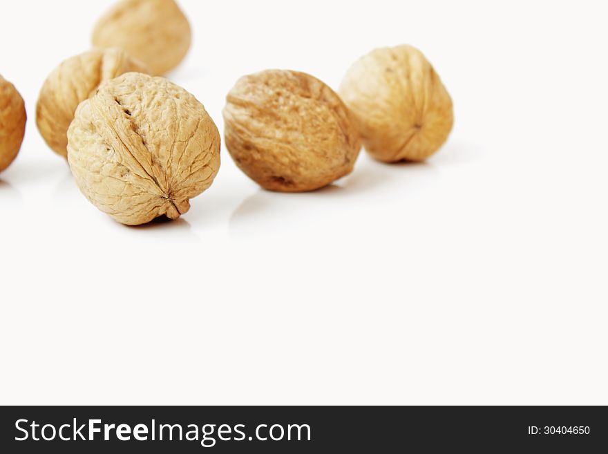 Shelled walnuts on the hite background
