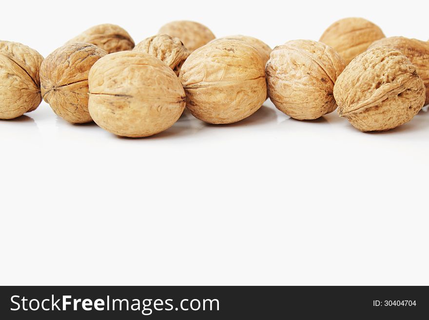 Shelled walnuts on the white background