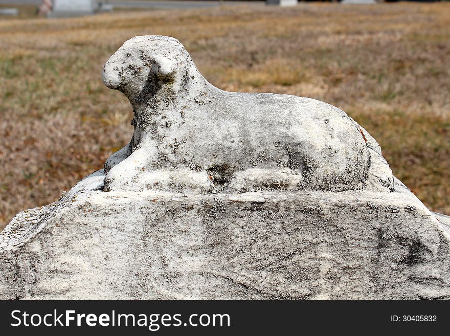 Stone statue of lamb on loved ones grave