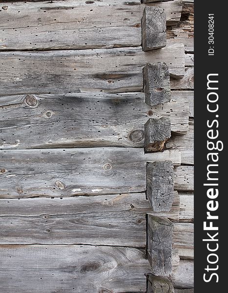 Background - a fragment of an old wooden house, damaged by beetles