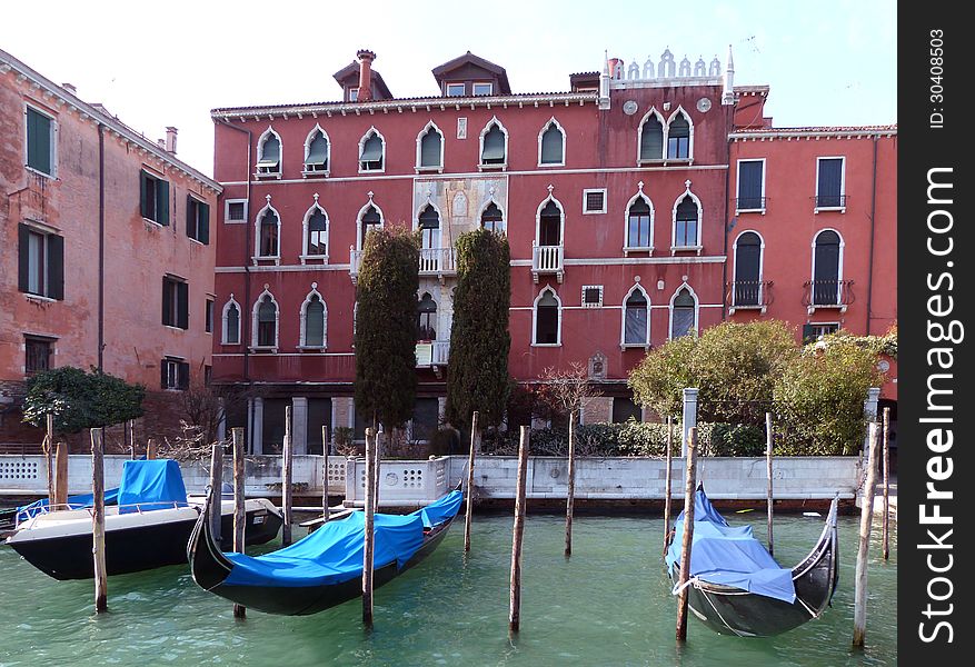 Venice - a view of gondols anchoring on the Grand Canal (Canal Grande) in front of an ancient palace. Venice - a view of gondols anchoring on the Grand Canal (Canal Grande) in front of an ancient palace