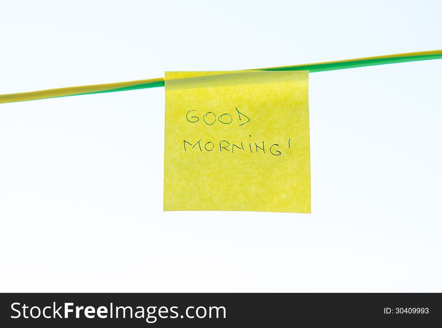 Good Morning text handwritten on a yellow sticky note. Good Morning text handwritten on a yellow sticky note