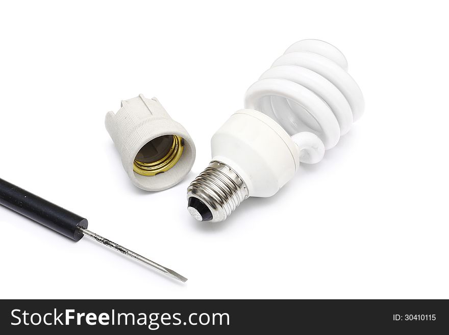 Compact florescent light bulb and screwdriver on white background