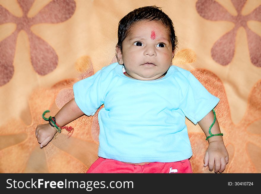 New born baby on colorful bed sheet