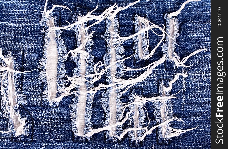 Creative embroidery on jeans, denim background. Creative embroidery on jeans, denim background