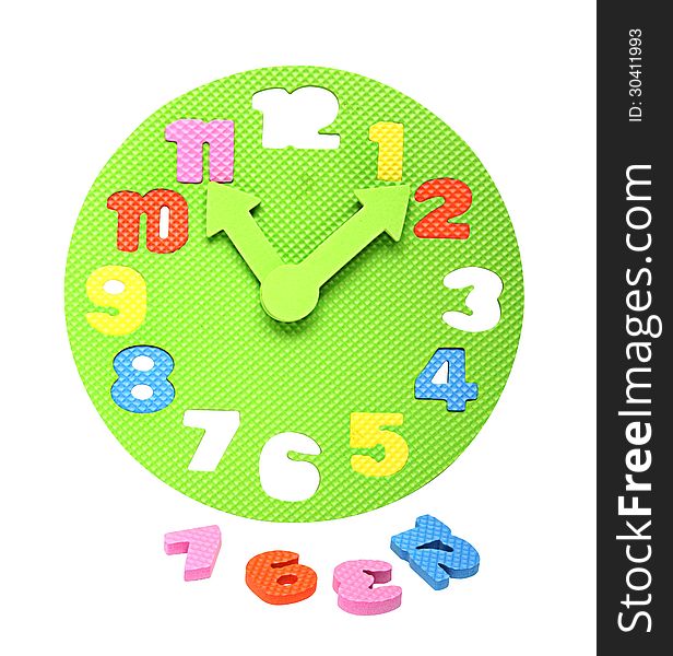 Image of a colorful foam clockface with detachable parts taken out, an educational toy to teach the concept of time to kids. Isolated on white. Clipping path included.
