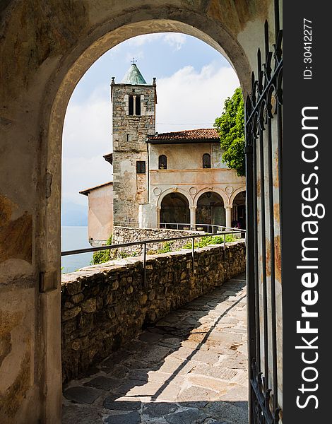 Monastery of Saint Catherine by Lake Maggiore, Leggiuno, Italy, seen through an archway. Monastery of Saint Catherine by Lake Maggiore, Leggiuno, Italy, seen through an archway.