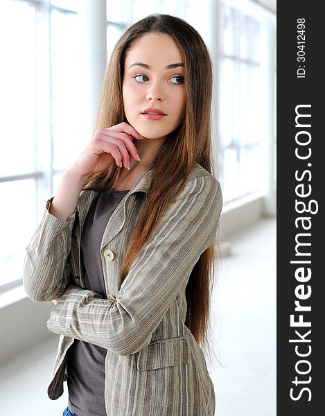 Young business girl with a folder in hands at office