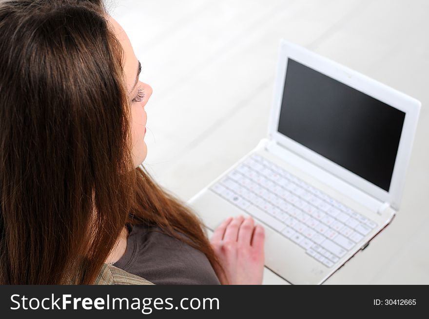 Young business girl with a notebook in hand in the office