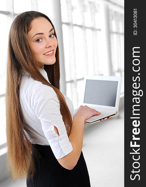 Young business girl with a notebook in hand in the office