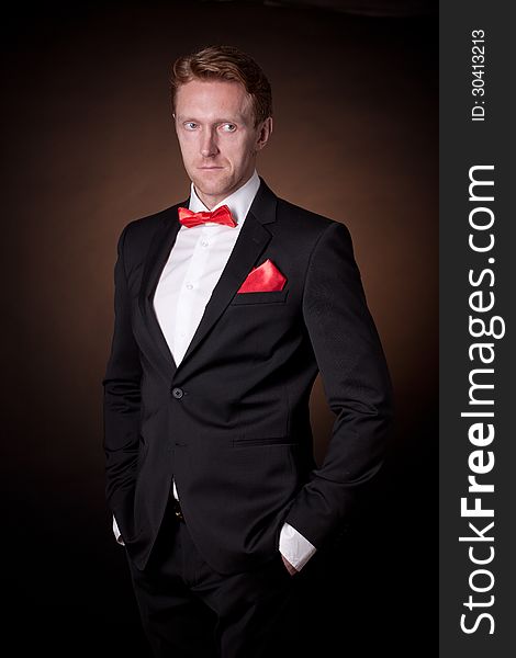 Elegant man in a tuxedo with a red bow