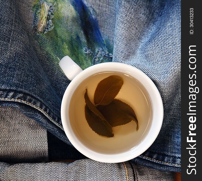 Cup of green tea, jeans