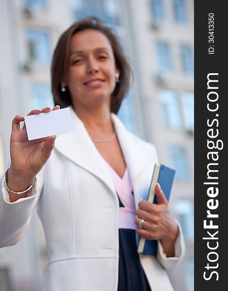 Beautiful businesswoman with visit card across office. Beautiful businesswoman with visit card across office