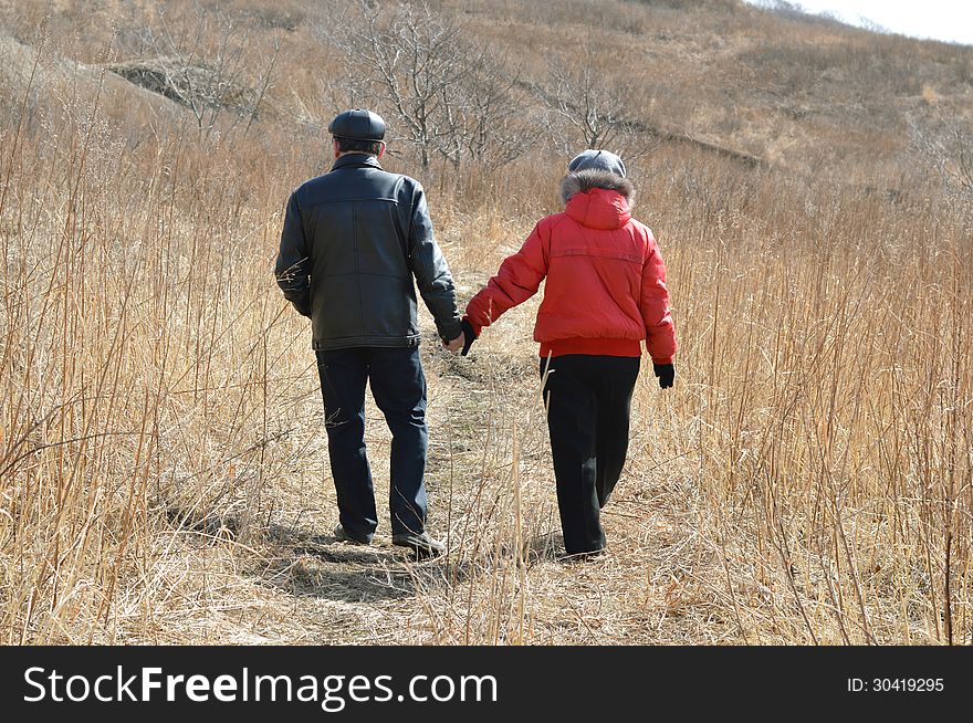 Man and women walking in the autumn field. Man and women walking in the autumn field