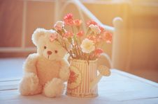 Teddy Bear And Flowers In The Pot Royalty Free Stock Photos