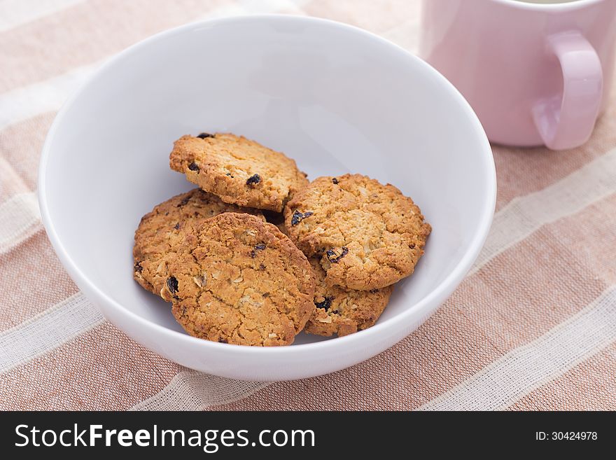 Home made chocolate chip cookies on a white plate