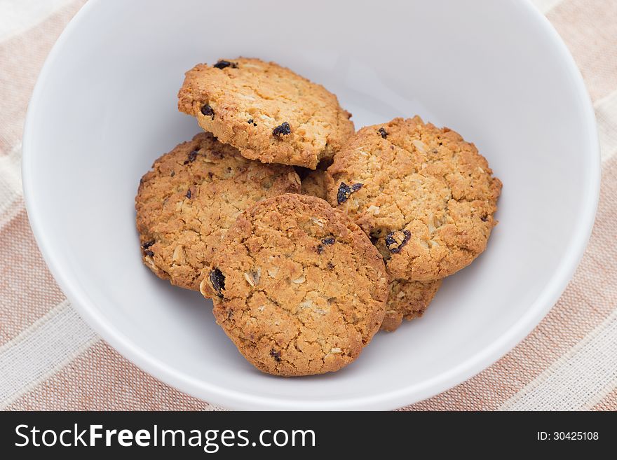 Home made chocolate chip cookies on a white plate