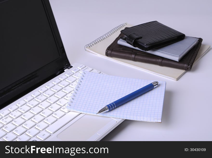 Laptop computer with books, pen and legal pad. Laptop computer with books, pen and legal pad